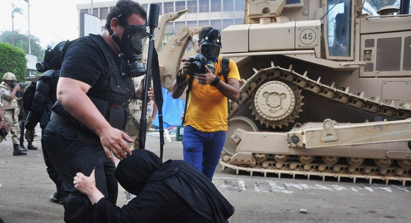 埃及開羅，一名婦女抓著安全部隊成員的腿