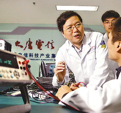 吳江（左）在實驗室和同事探討業務